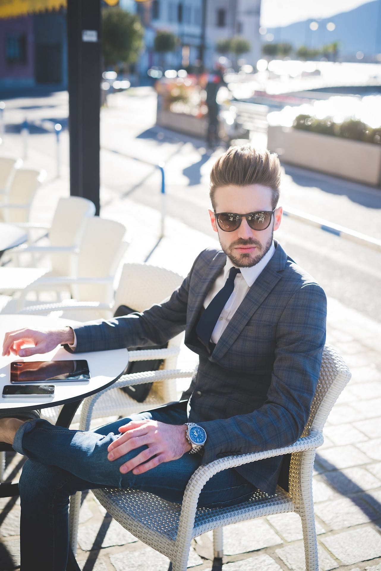 Portrait of stylish young businessman at sidewalk cafe